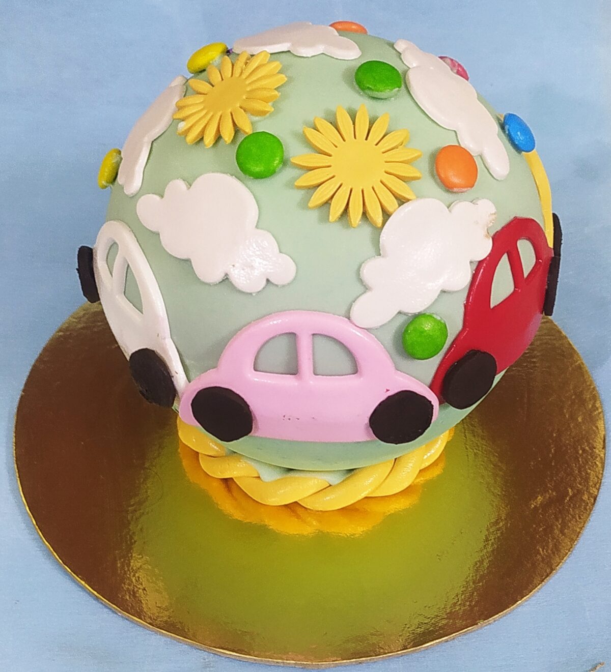 ball shape pinata cake with fondant designs