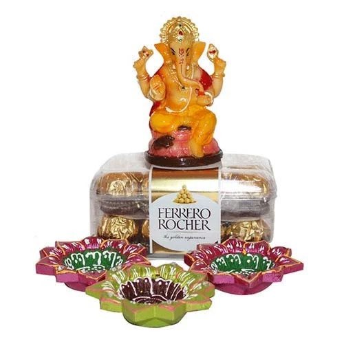 Ganesha Idol with chocolates and Diyas